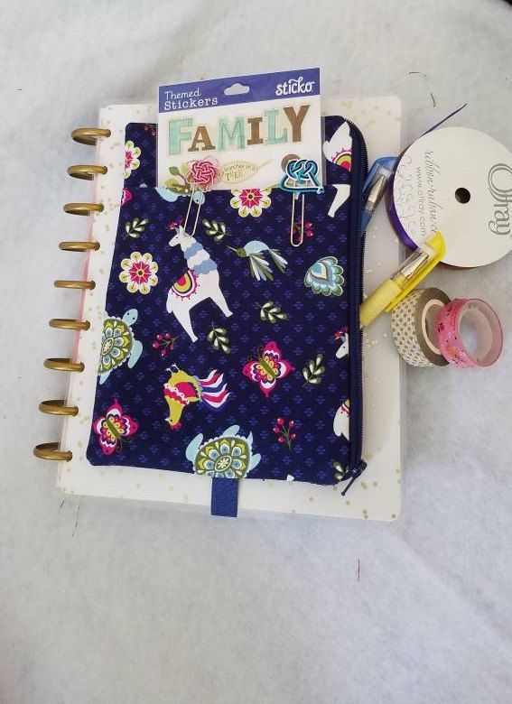 A Binder With An Animal Design On It Next To Some Scissors And Other Items