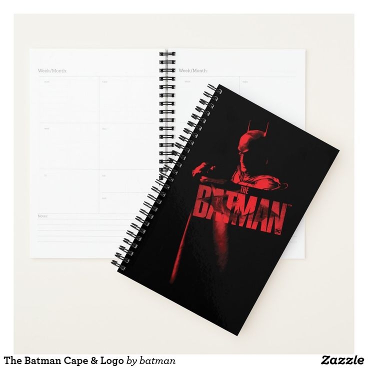A Spiral Notebook With The Batman Logo On It